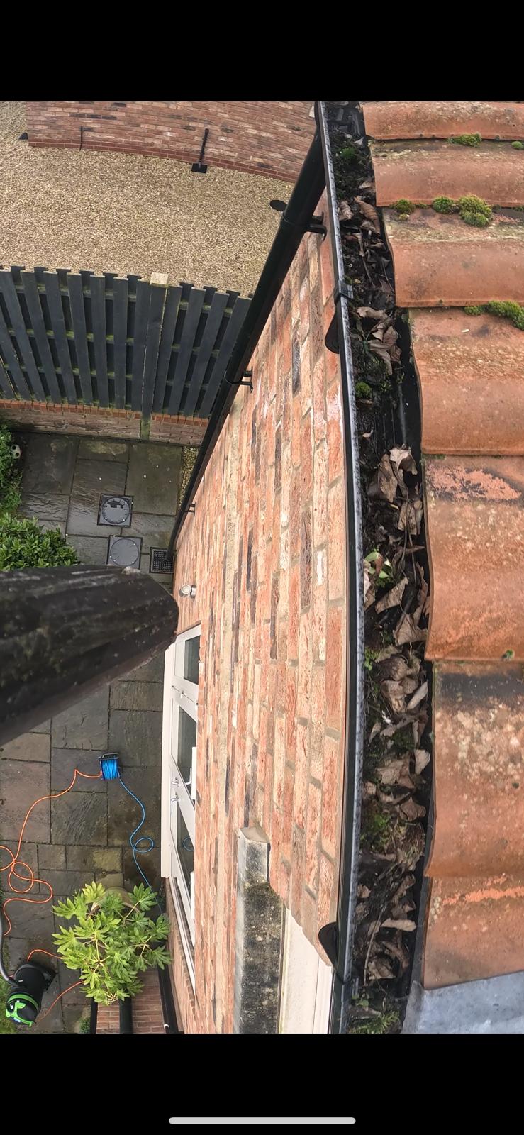 Gutters packed with leaves and debris — before clear